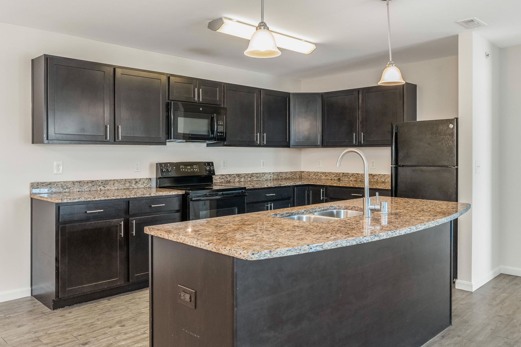 Luxury apartment kitchen with stainless steel appliances, granite countertops, and lots of storage space